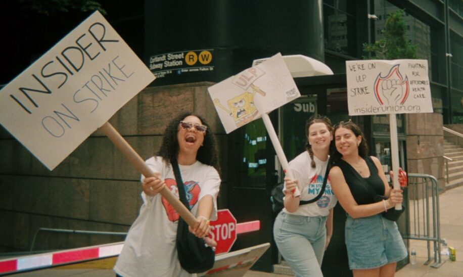 Photo of three women holding picket signs: Insider Union members at the picket line in lower Manhattan who struck for 13 days in June 2023
