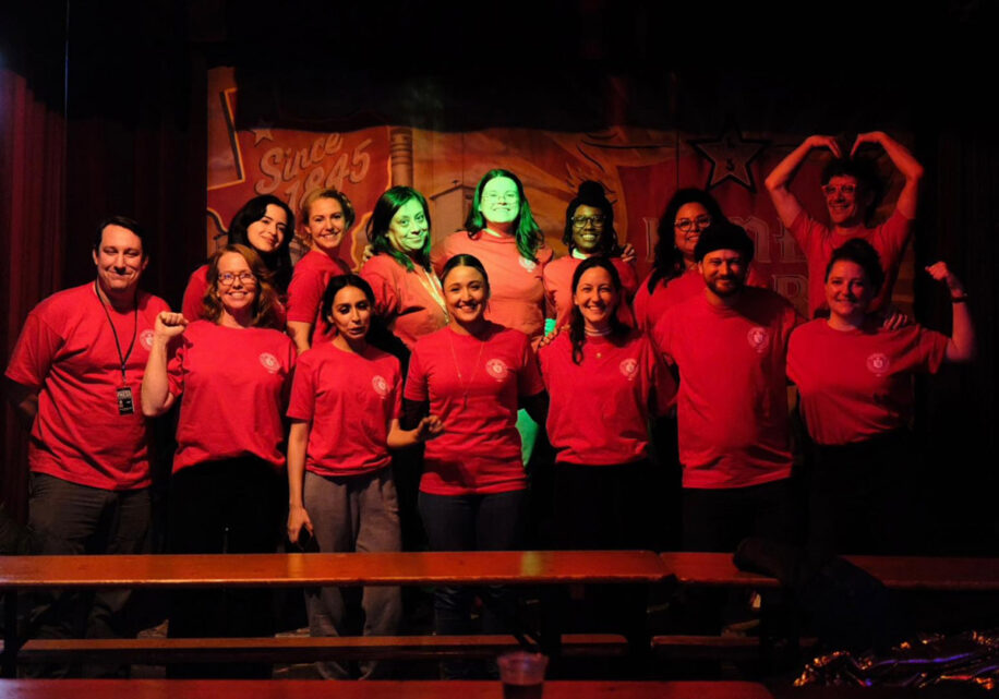 Photo of the workers at the San Antonio Report wearing red shirts after going public with their union in January 2024
