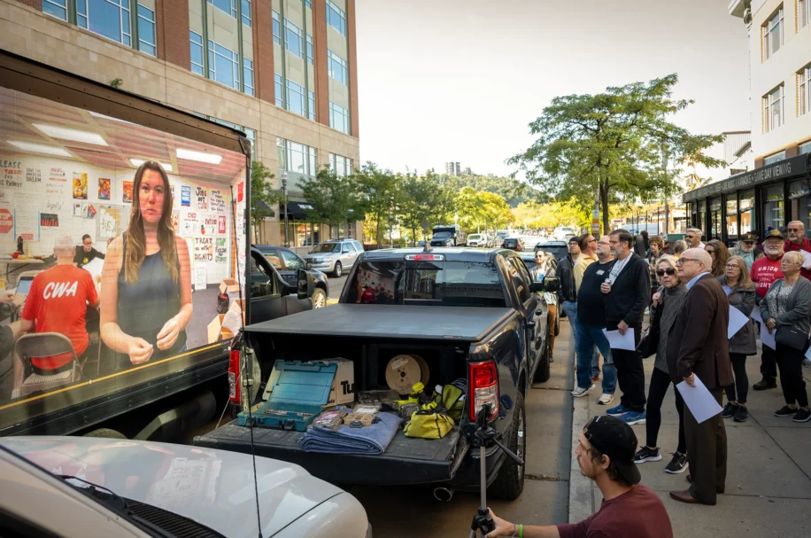 The video image of Pittsburgh Post-Gazette striker Alexandra Wimley appears on a billboard truck outside the PG newsroom on North Shore Drive on the North Shore on Tuesday, Oct. 8, 2024. The billboard truck was part of an effort to mark the two-year anniversary of the strike. (Steve Mellon/Pittsburgh Union Progress)