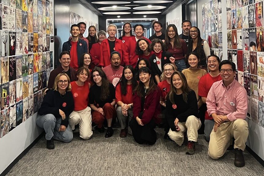 Union members at The New Yorker pose for a photo announcing a 100% strike authorization vote.