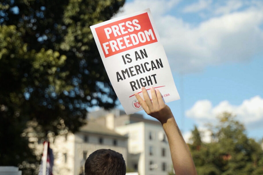 Person holding sign that reads "Press Freedom is an American right"