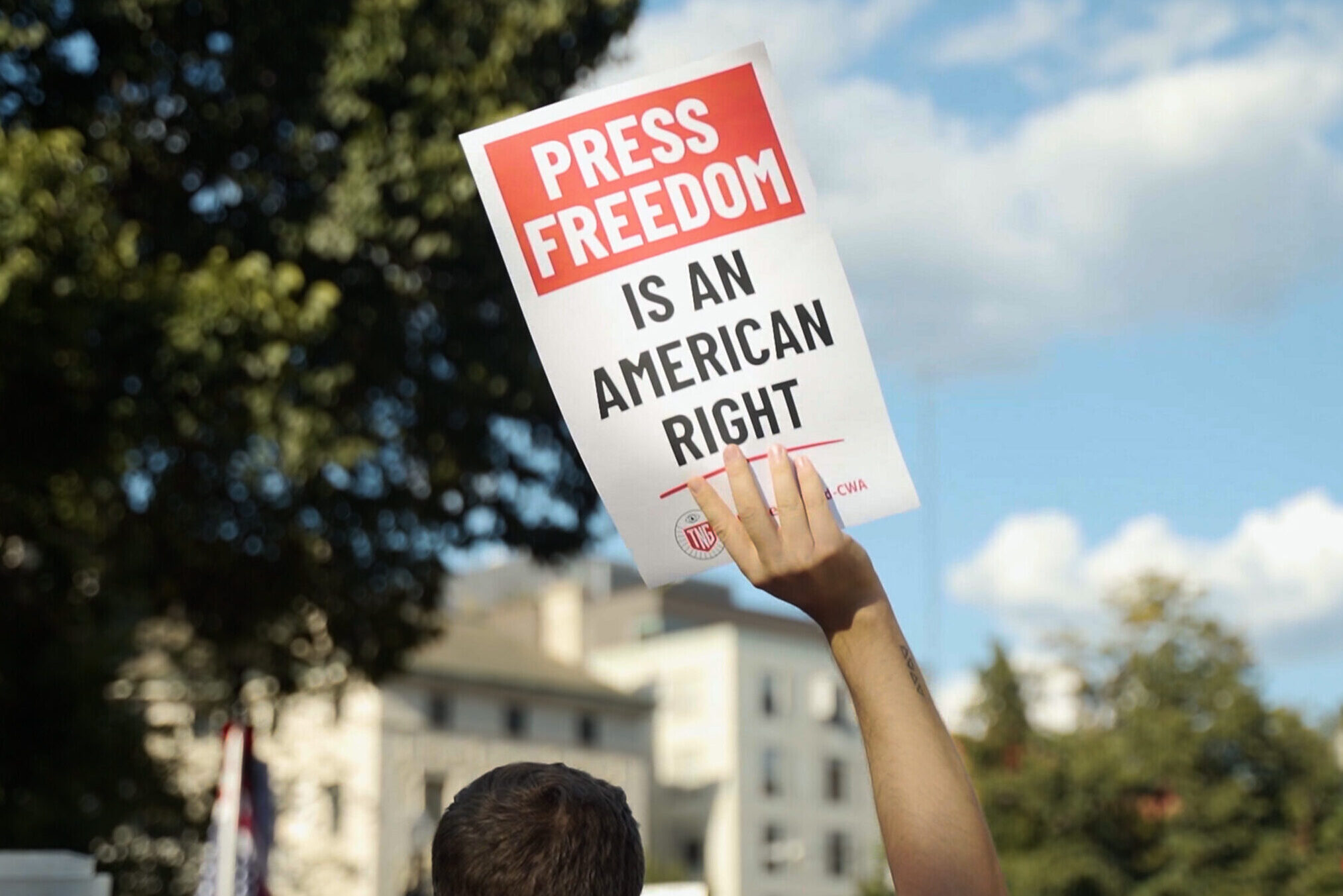 Person holding sign that reads "Press Freedom is an American right"